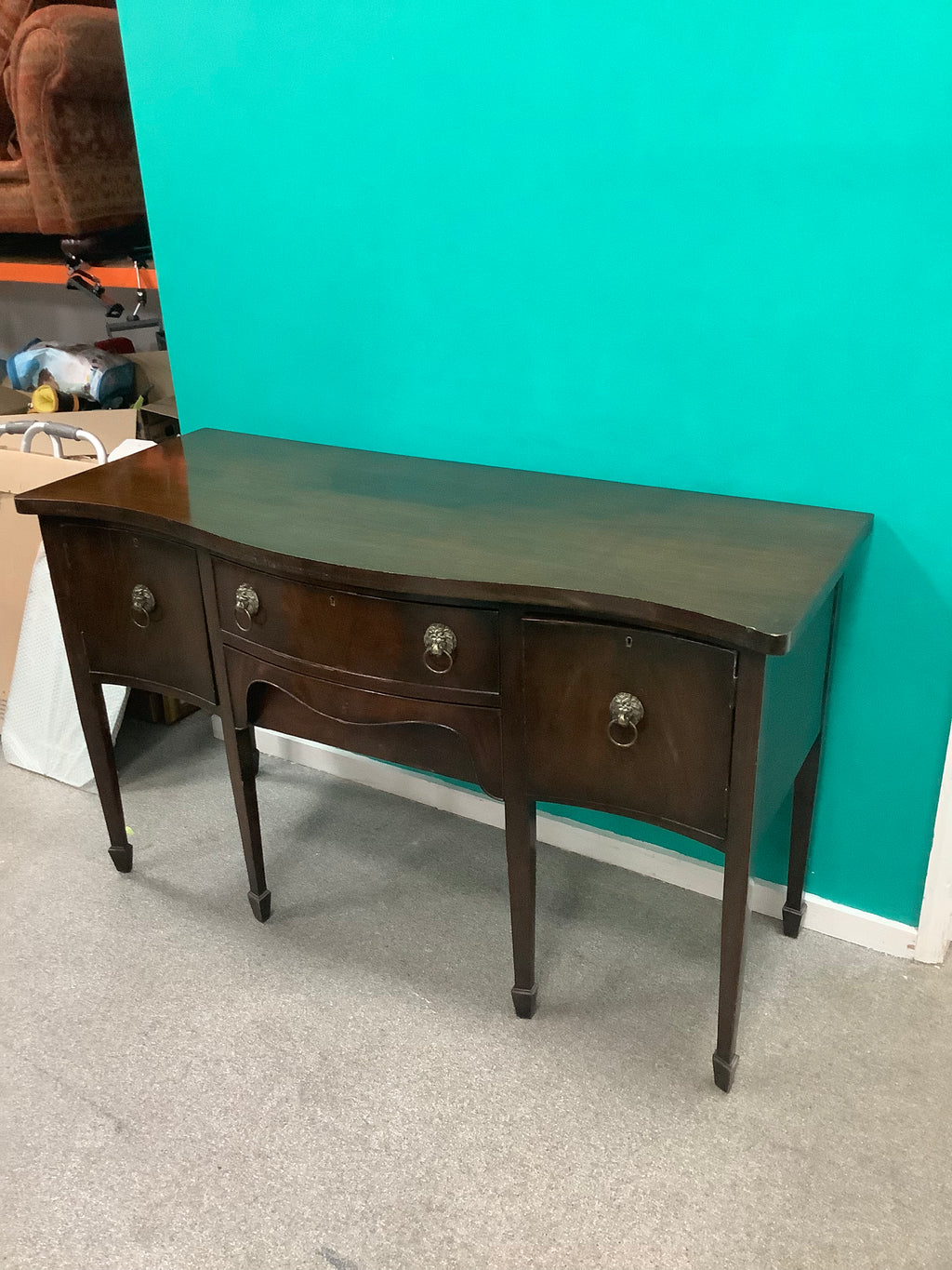 mahogany serpentine-front sideboard featuring distinct brass lion-mask ring pull handles 170826008