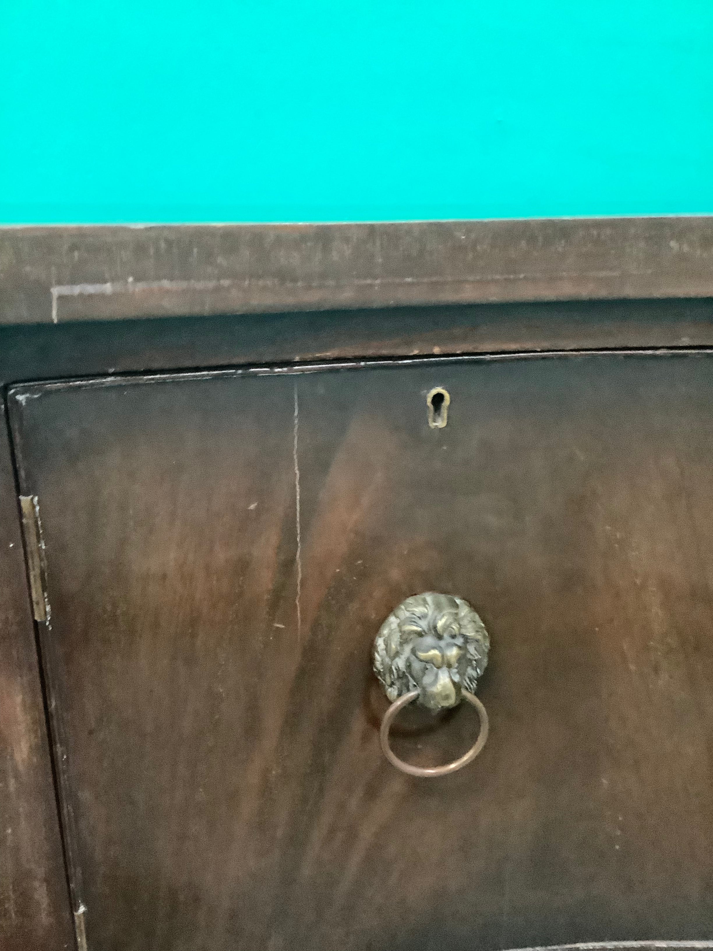 mahogany serpentine-front sideboard featuring distinct brass lion-mask ring pull handles 170826008