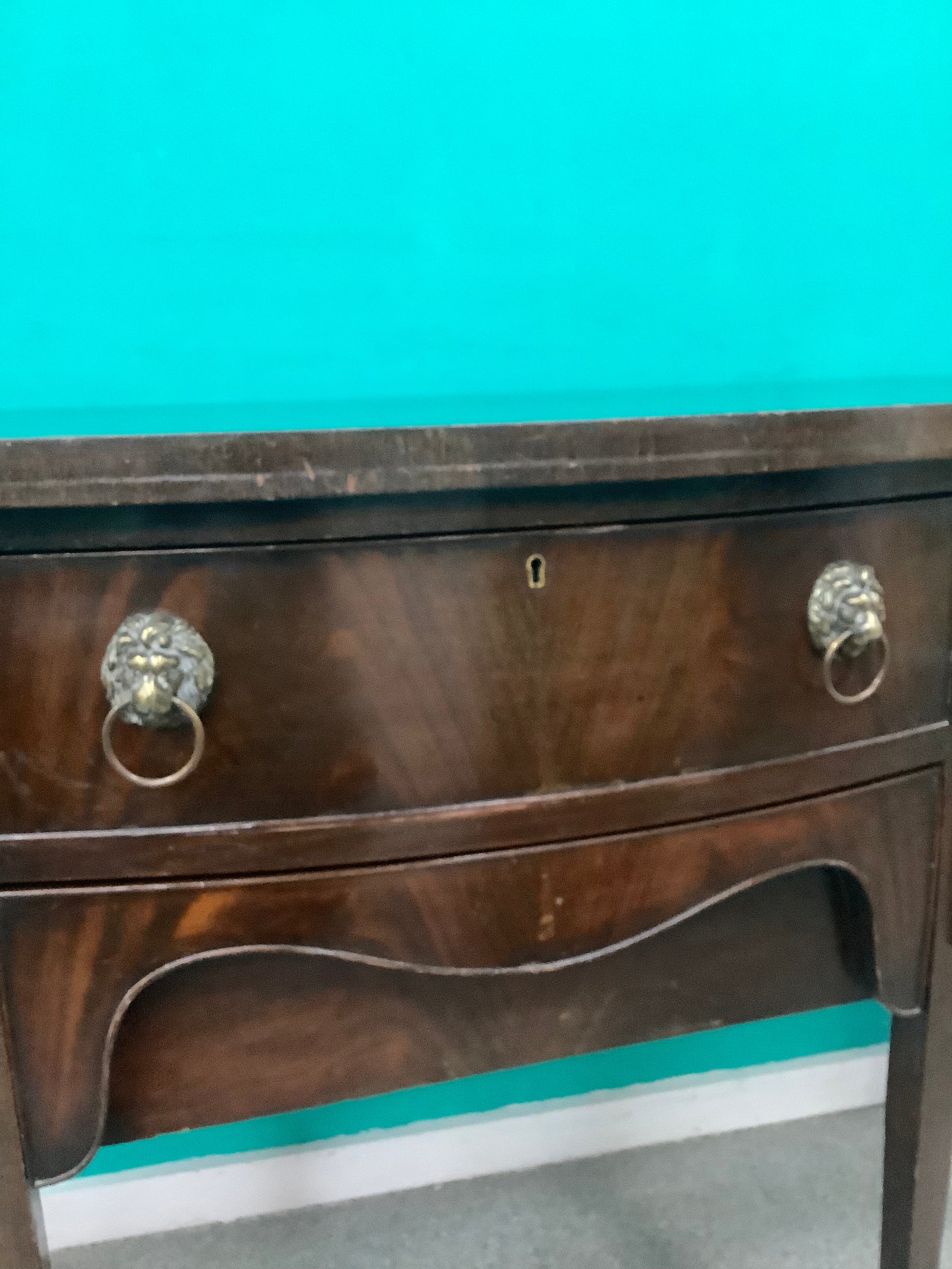mahogany serpentine-front sideboard featuring distinct brass lion-mask ring pull handles 170826008