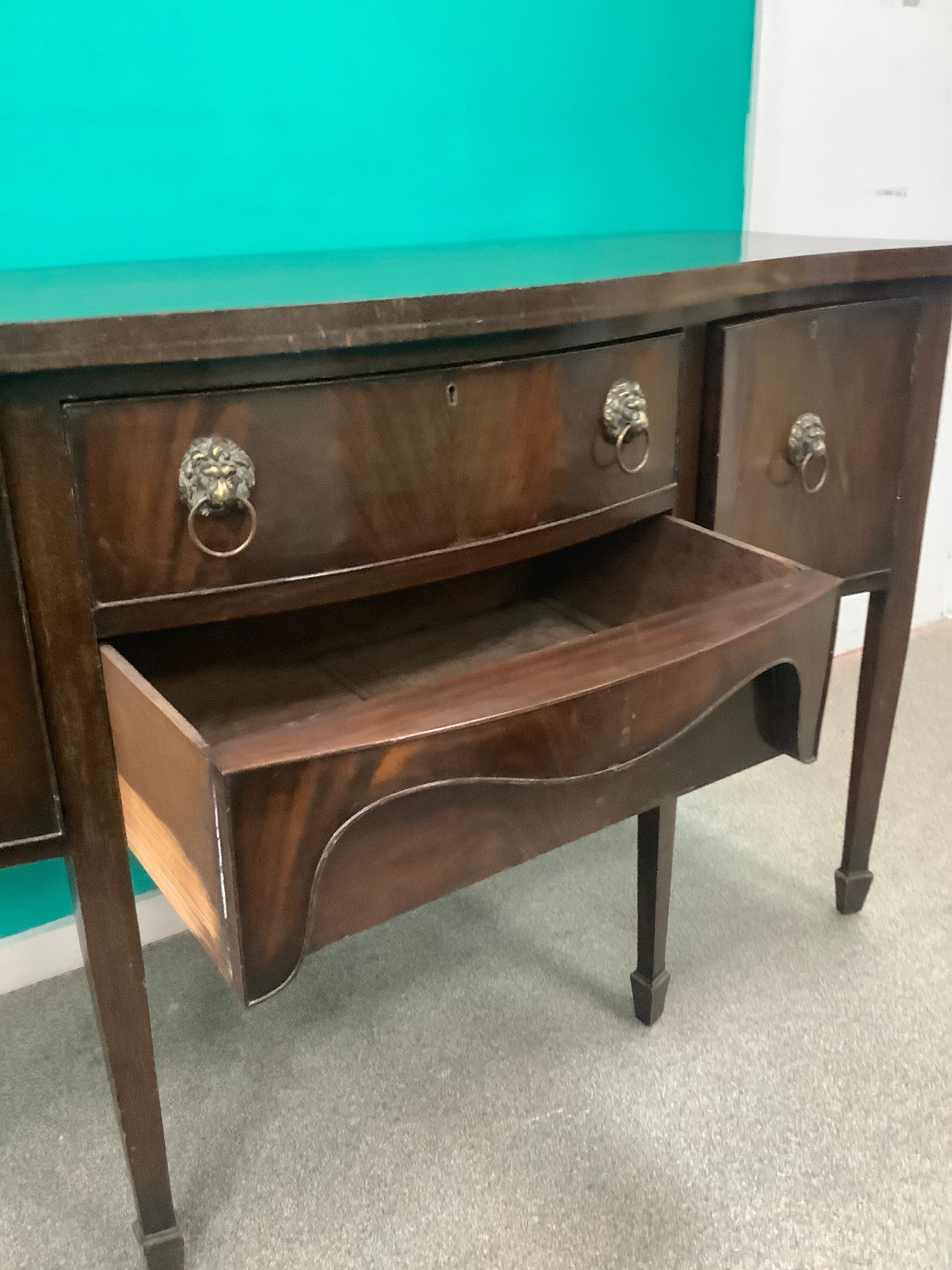 mahogany serpentine-front sideboard featuring distinct brass lion-mask ring pull handles 170826008