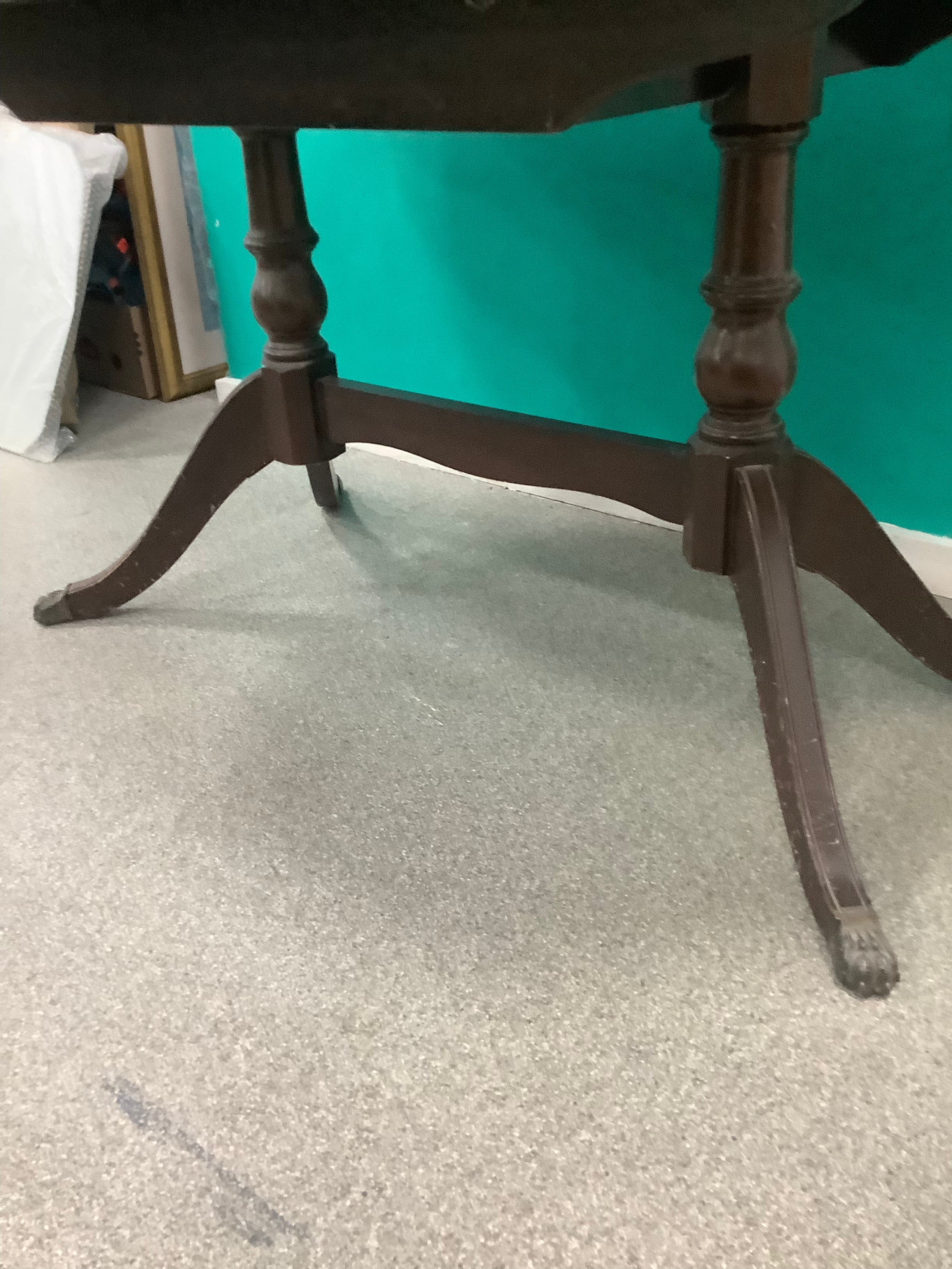 mahogany Regency-style double-pedestal extending dining table features an oval top and classic reeded saber legs with claw feet. 10826007