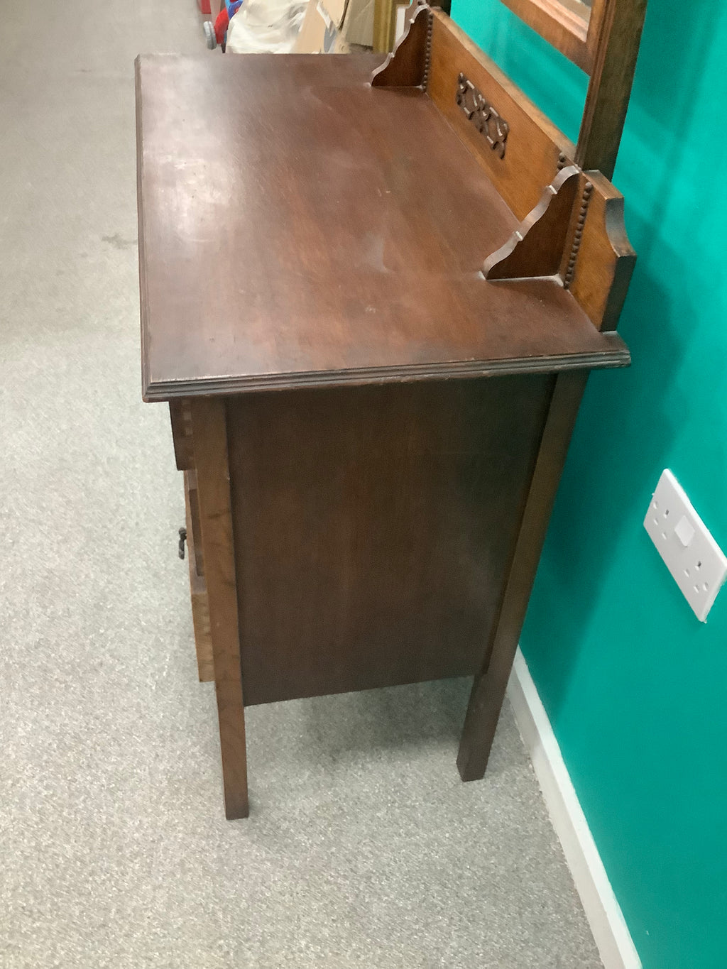 An antique Edwardian Arts & and Crafts dark oak dressing chest featuring a swing vanity mirror, decorative pierced metal drop handles, and a three-drawer configuration. 170826009