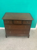 Stag Minstrel 3-over-2 chest of drawers, designed by John & Sylvia Reid in the mid-20th century and crafted from mahogany or cherry veneers with distinctive brass-toned ring pull handles. 190826003