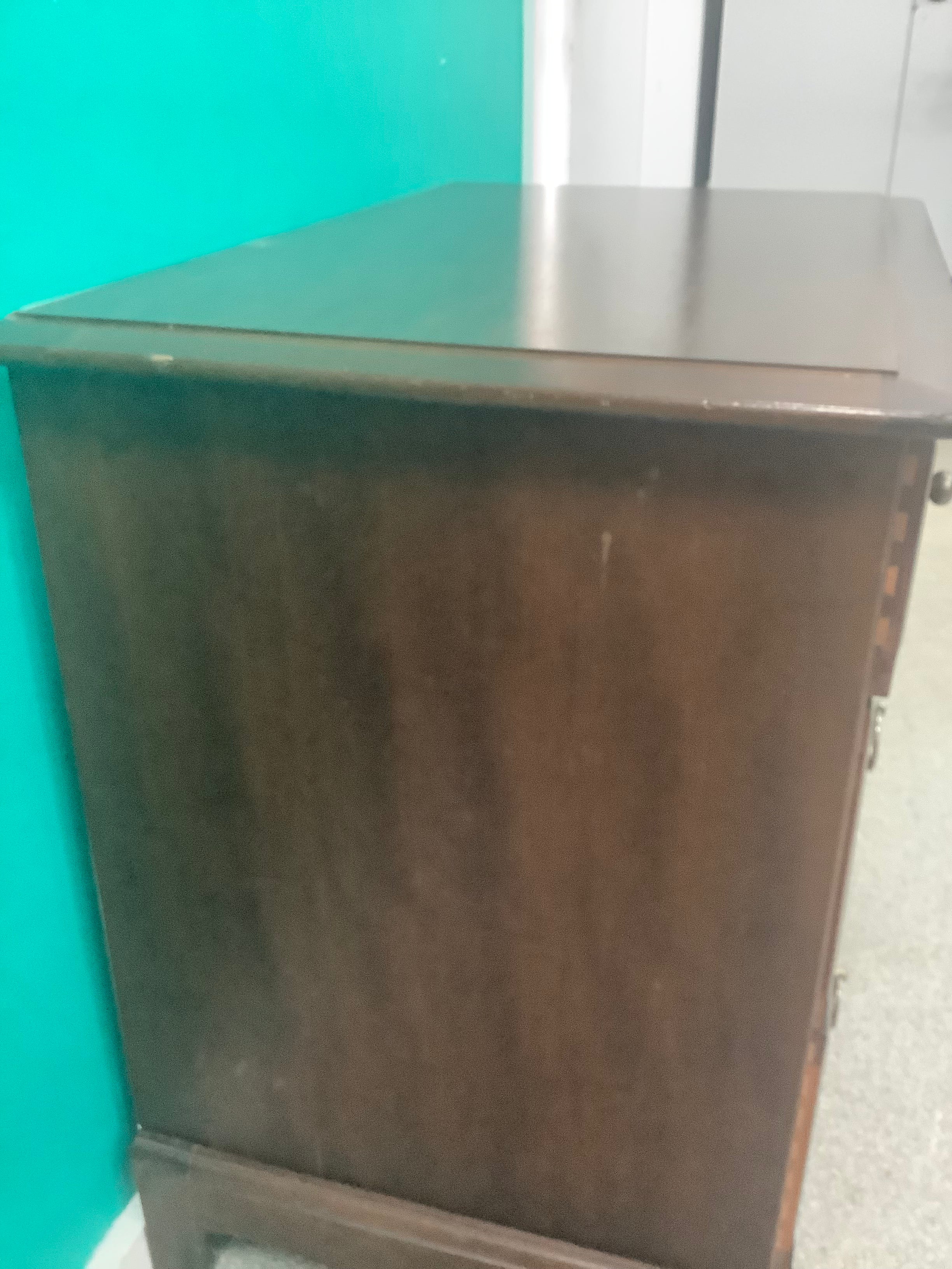 Stag Minstrel 3-over-2 chest of drawers, designed by John & Sylvia Reid in the mid-20th century and crafted from mahogany or cherry veneers with distinctive brass-toned ring pull handles. 190826003