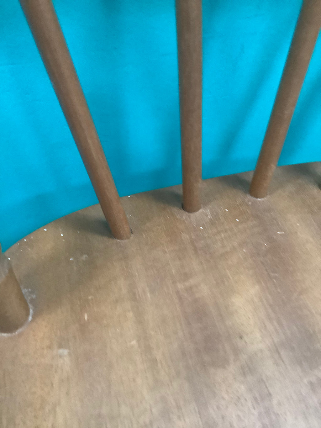 Windsor-style wooden bar stool features a spindle-back design with turned leg supports and multiple footrest stretchers for stability.210826004