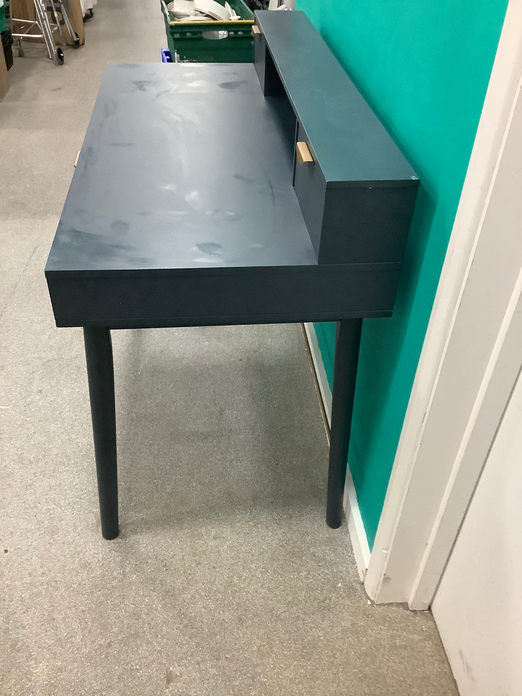 This is the dark blue or charcoal vintage-style "Penelope" 3-drawer desk by Maisons du Monde, featuring distinct brass-finish half-moon handle pulls and an elevated upper tier with integrated small compartments. 240826004